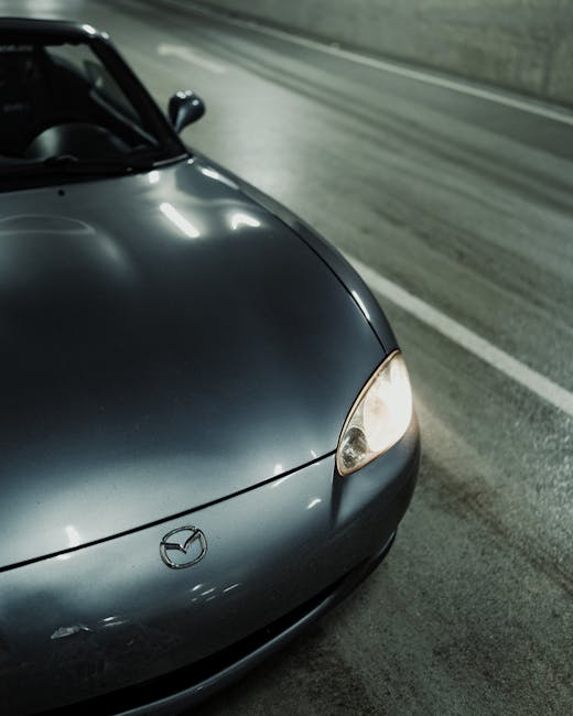 Close up of a modern car headlight and logo